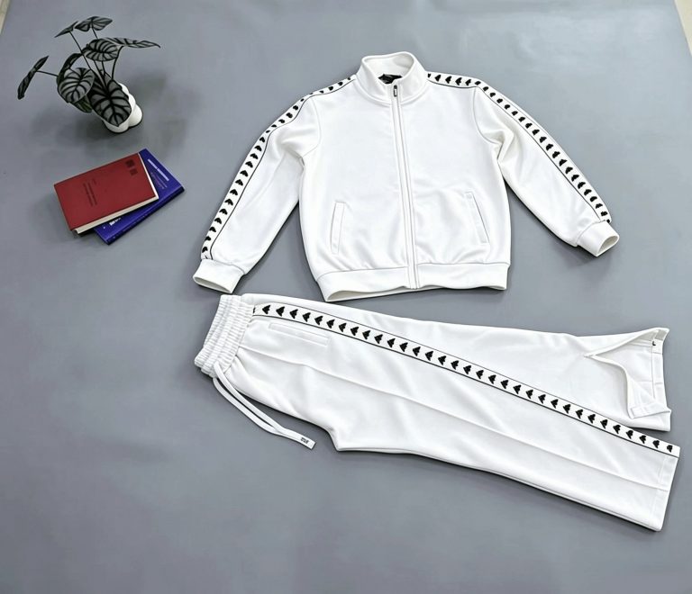 White zip-front tracksuit jacket and trousers laid flat
