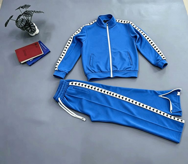 Blue zip-front tracksuit jacket and trousers laid flat