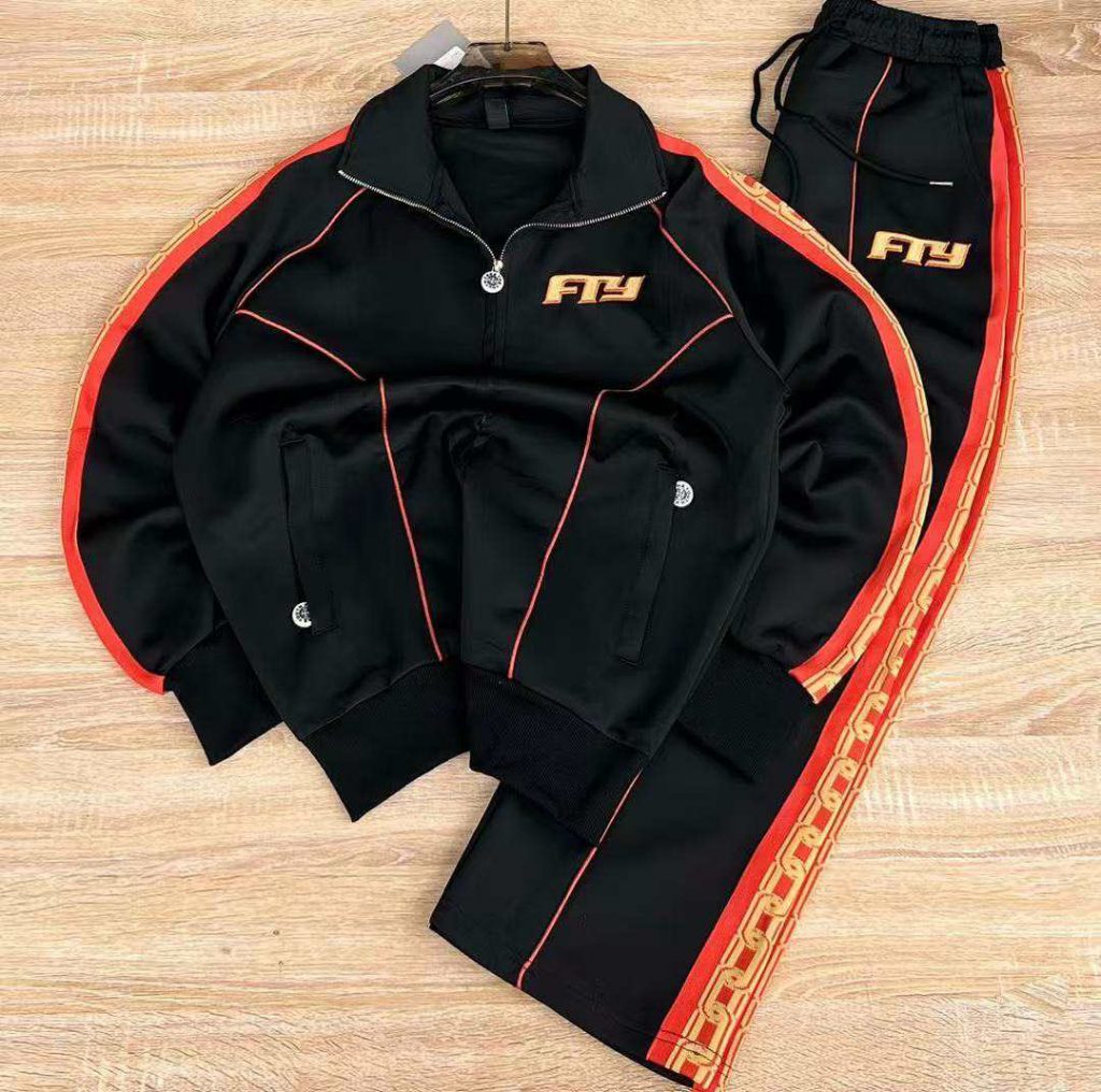 Black jacket and matching trousers laid flat with red side trim.