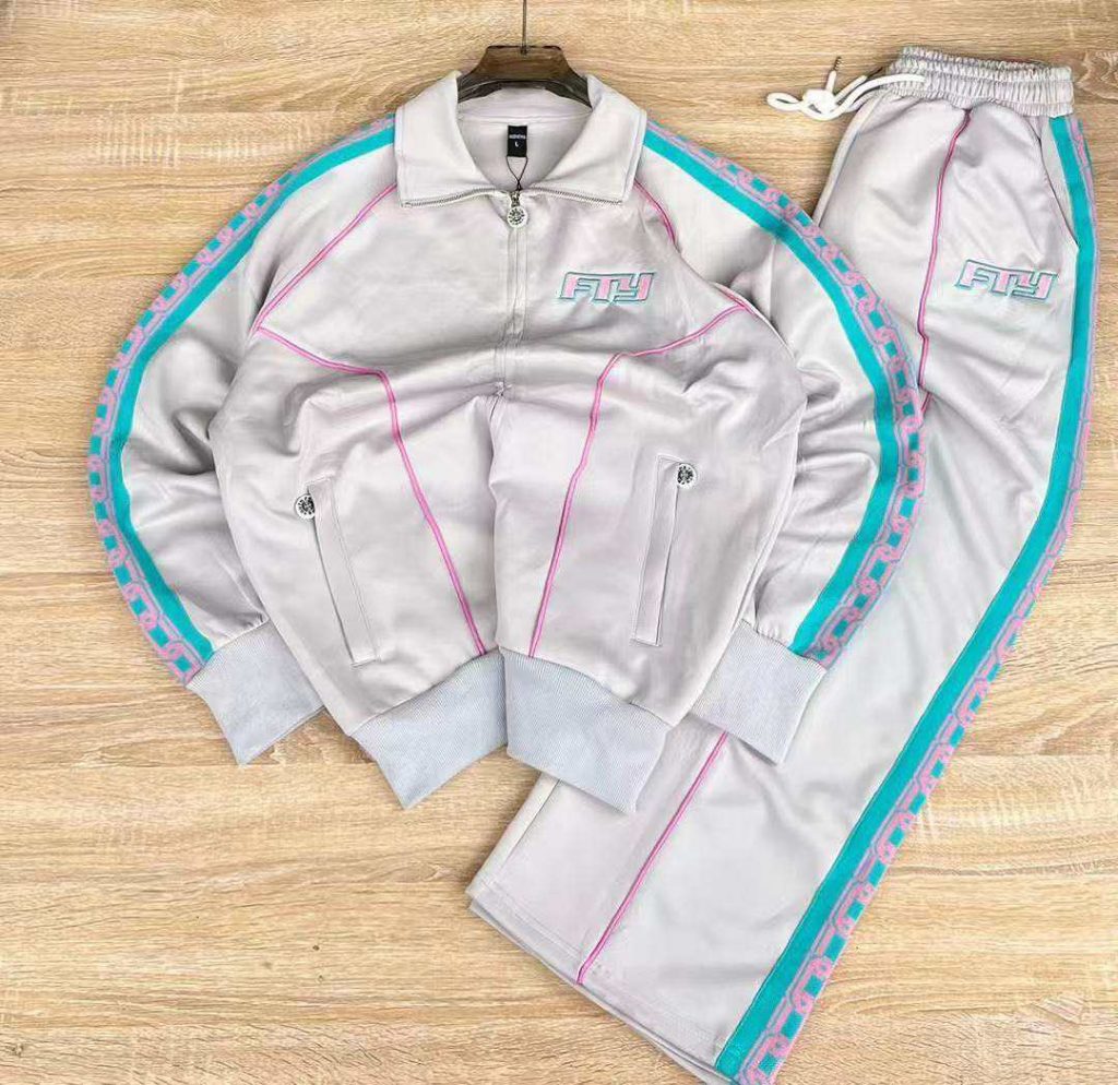 Light grey jacket and matching trousers with turquoise side trim.