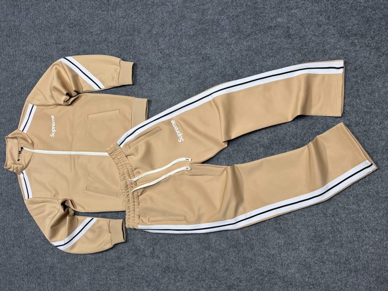 Khaki men's tracksuit laid flat with jacket and trousers visible